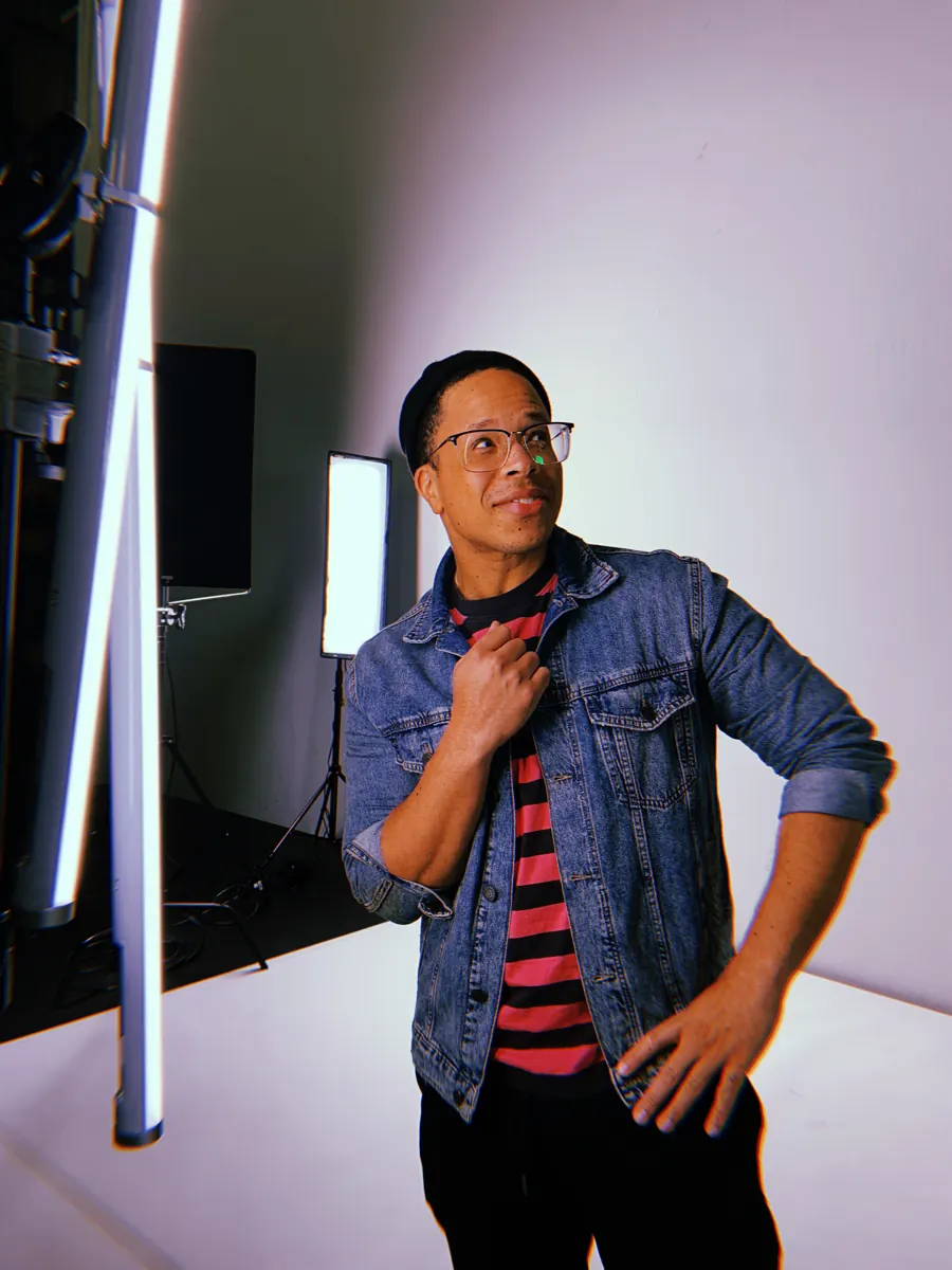 OKAY TK posing in a denim jacket, studio portrait